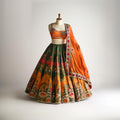 Colorful CoutureMantra sari and lehenga set with intricate embroidery, displayed on a mannequin.
