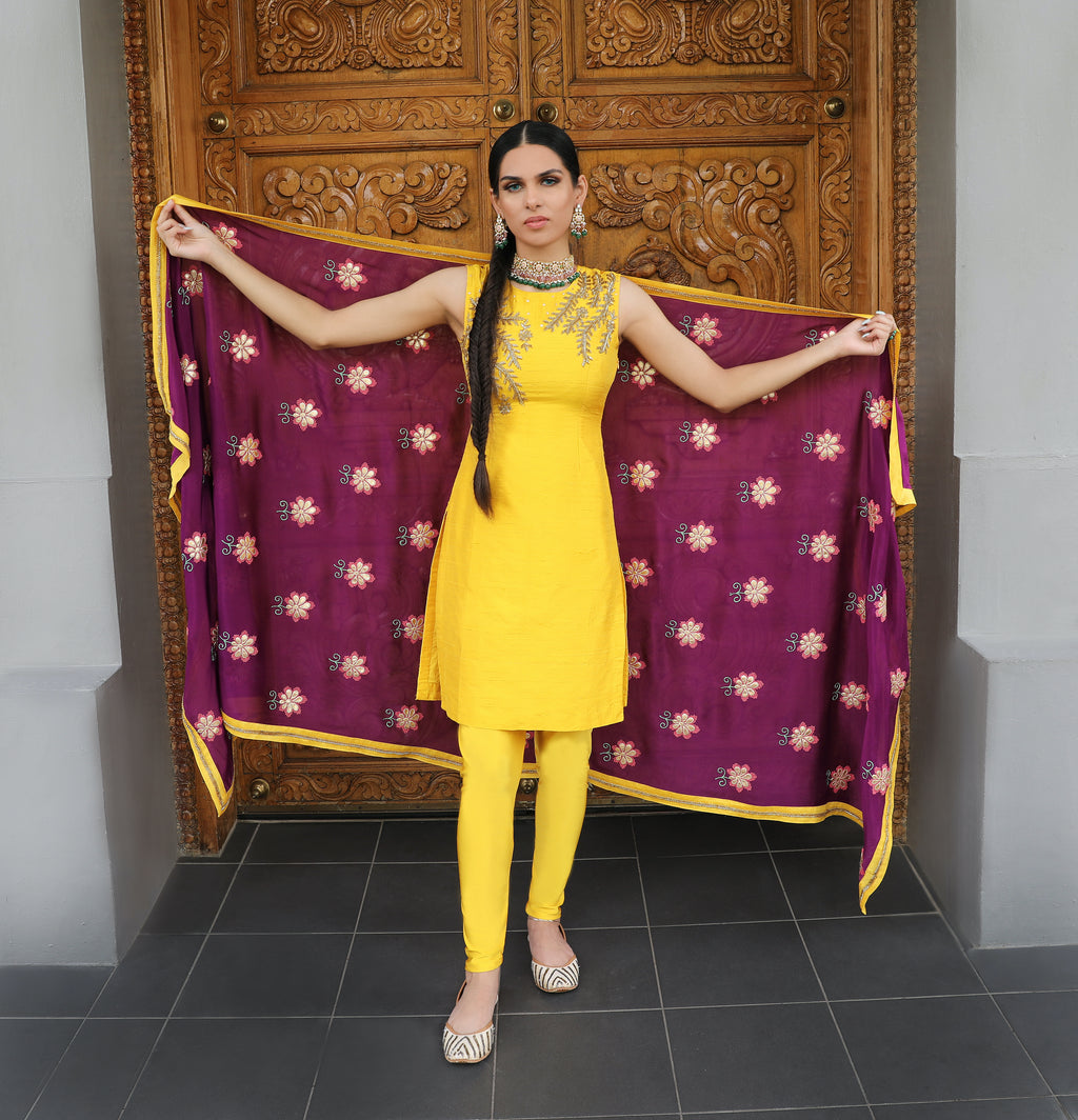Yellow and purple Begum Kurti set pajami suit by Couture Mantra with intricate embroidery, displayed on a hanger.