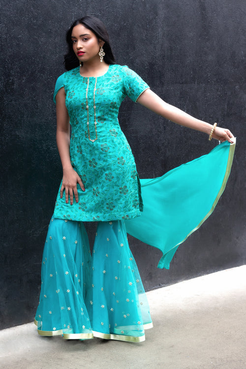 Cotton Mul Gharara set by Couture Mantra featuring a traditional sharara with intricate embroidery and vibrant colors.