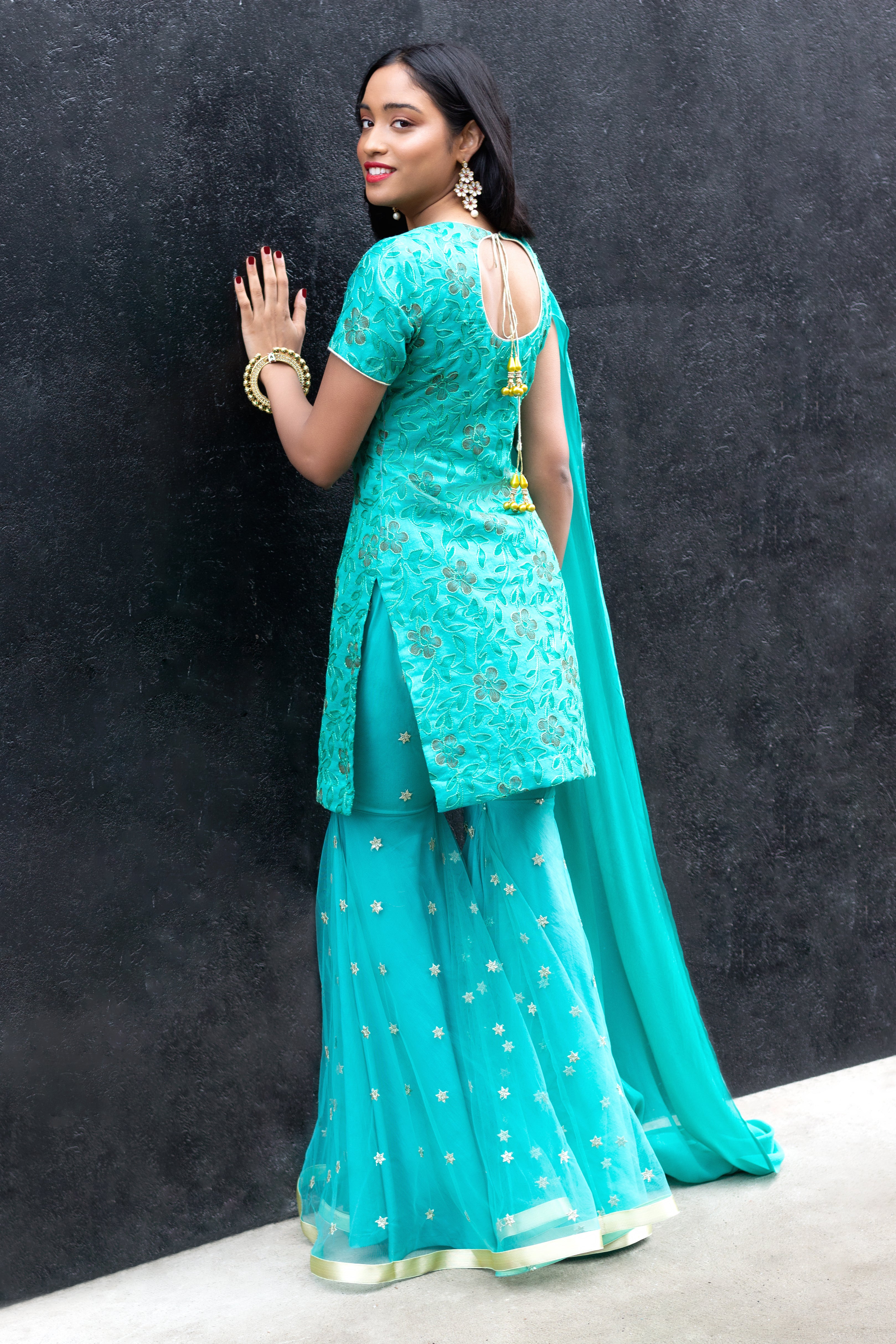Cotton Mul Gharara set by Couture Mantra featuring a traditional sharara with intricate embroidery and matching top.
