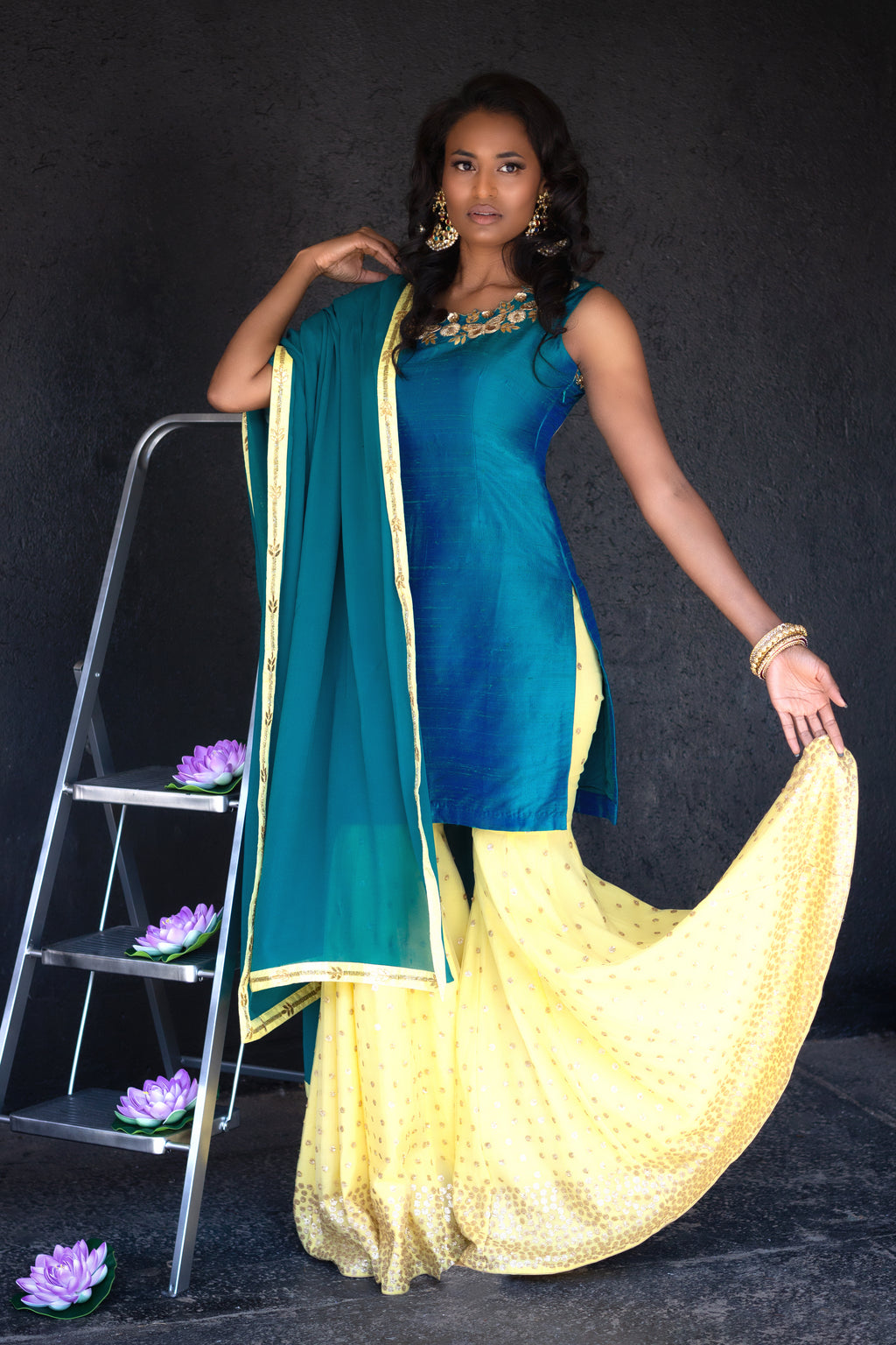 Peacock blue and yellow sharara pants by Couture Mantra, featuring intricate embroidery and traditional Indian design.