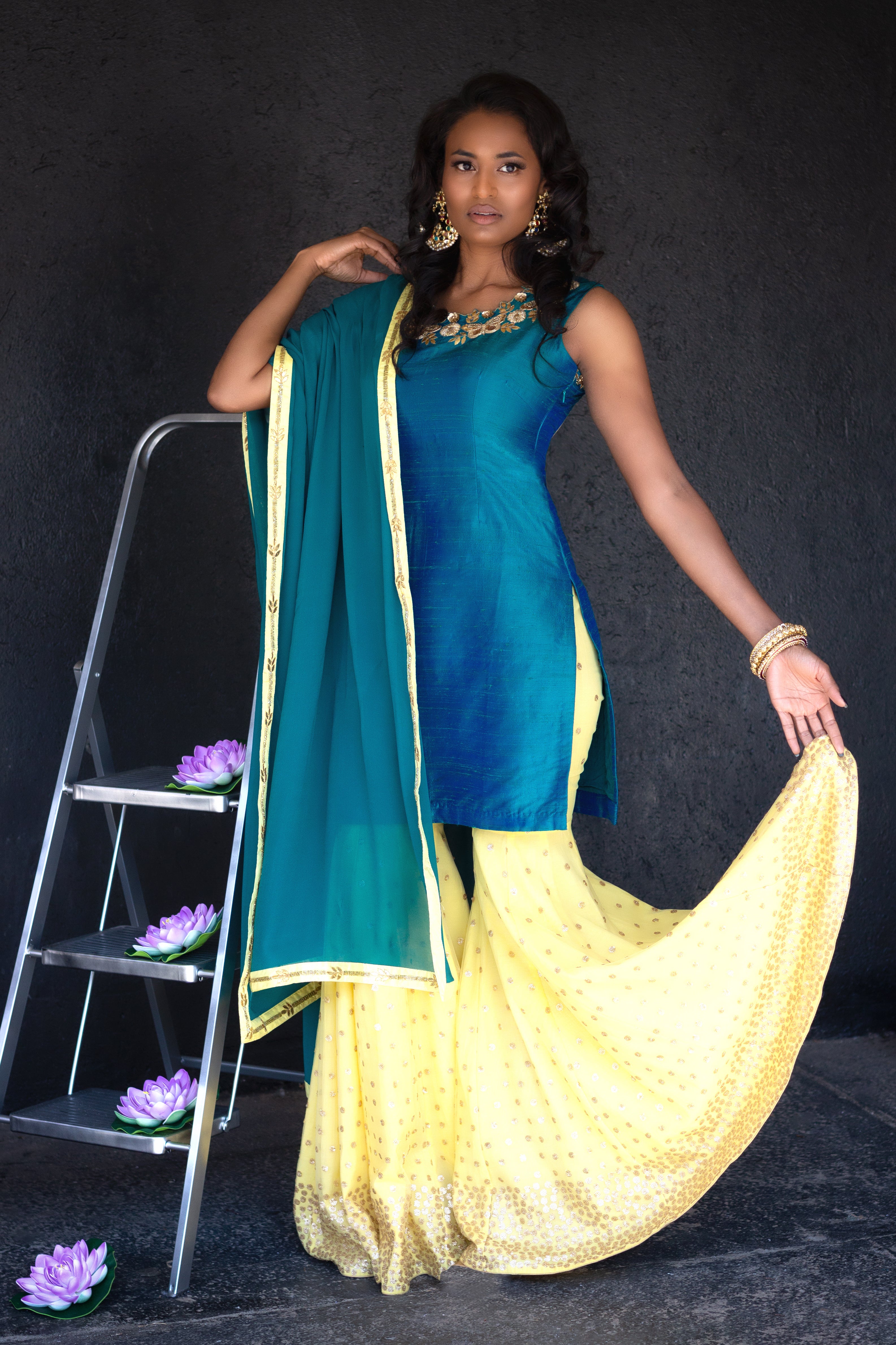 Peacock blue and yellow sharara pants by Couture Mantra, featuring intricate embroidery and traditional Indian design.