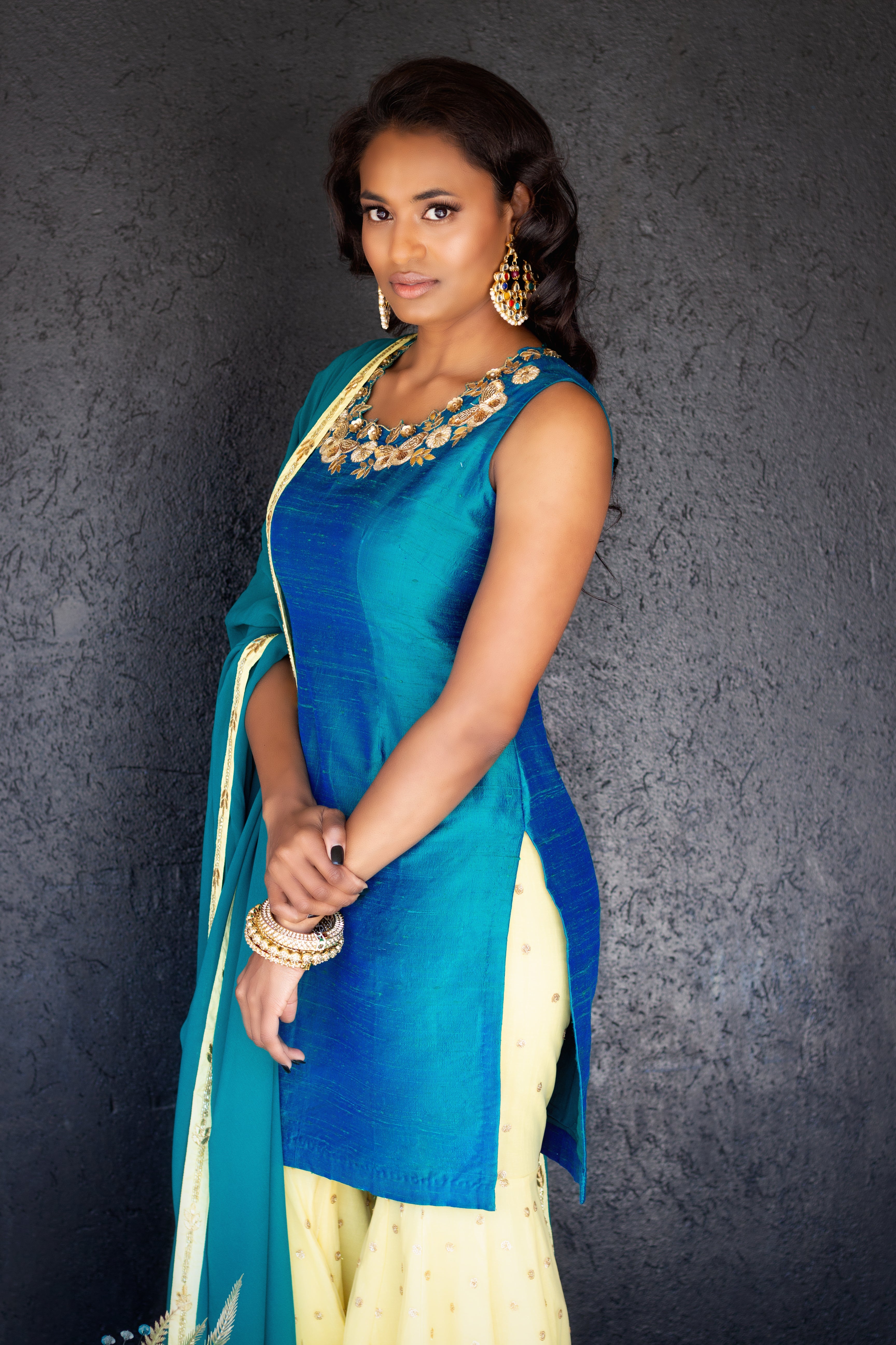 Peacock blue and yellow Rani Gharara Sharara by Couture Mantra, featuring intricate embroidery and traditional design.