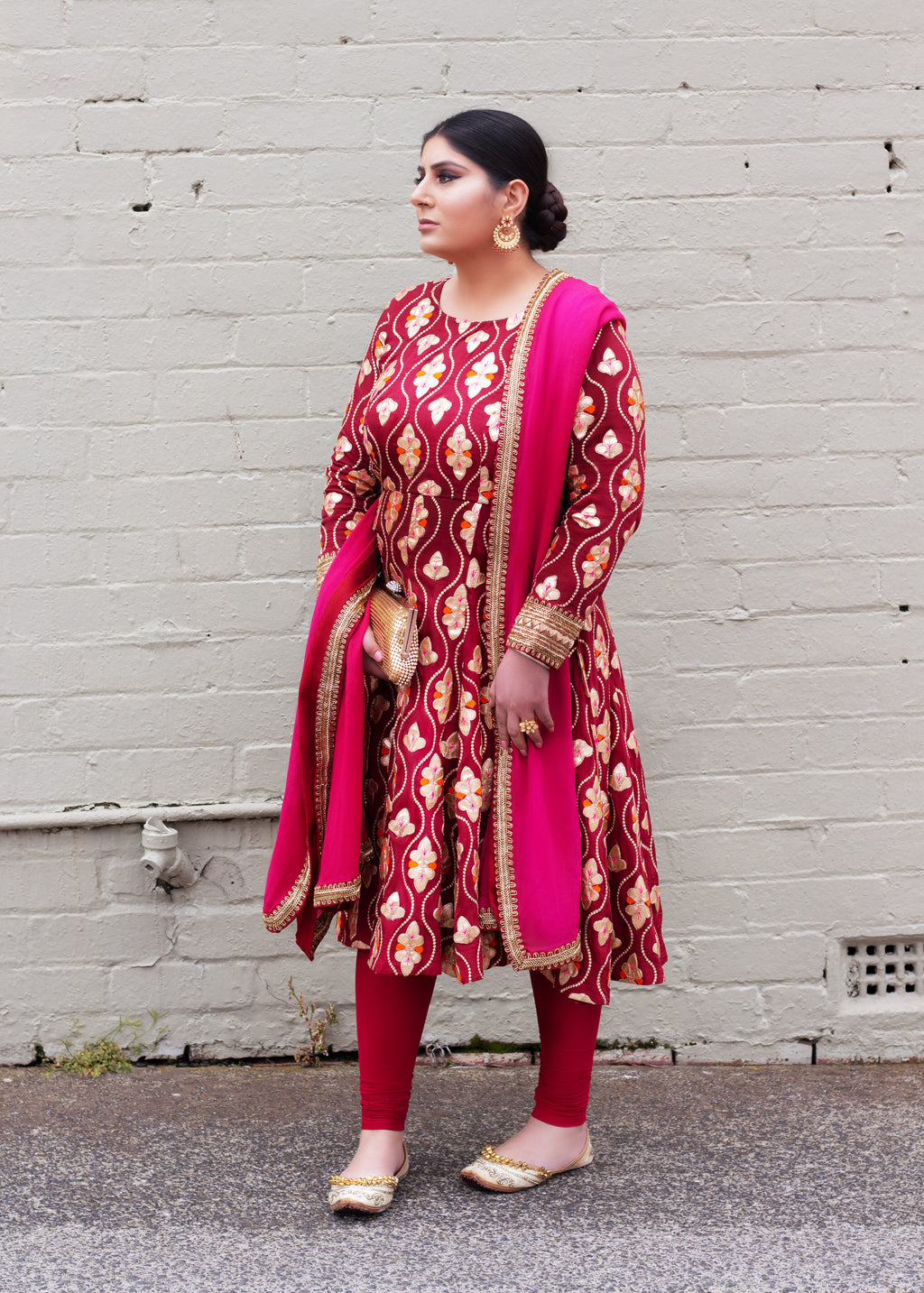 Maroon Patiyala frock by Amanpreet, featuring traditional embroidery and flowy fabric, displayed on a hanger.