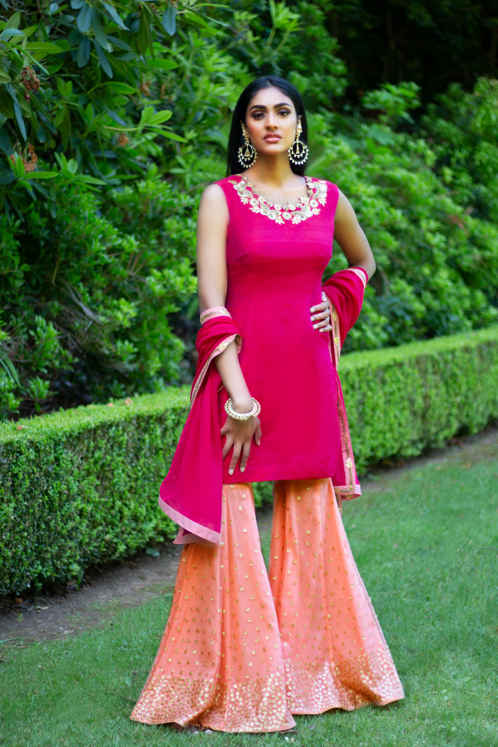 Pink and peach Rani Gharara Sharara by Couture Mantra featuring intricate embroidery and traditional styling.