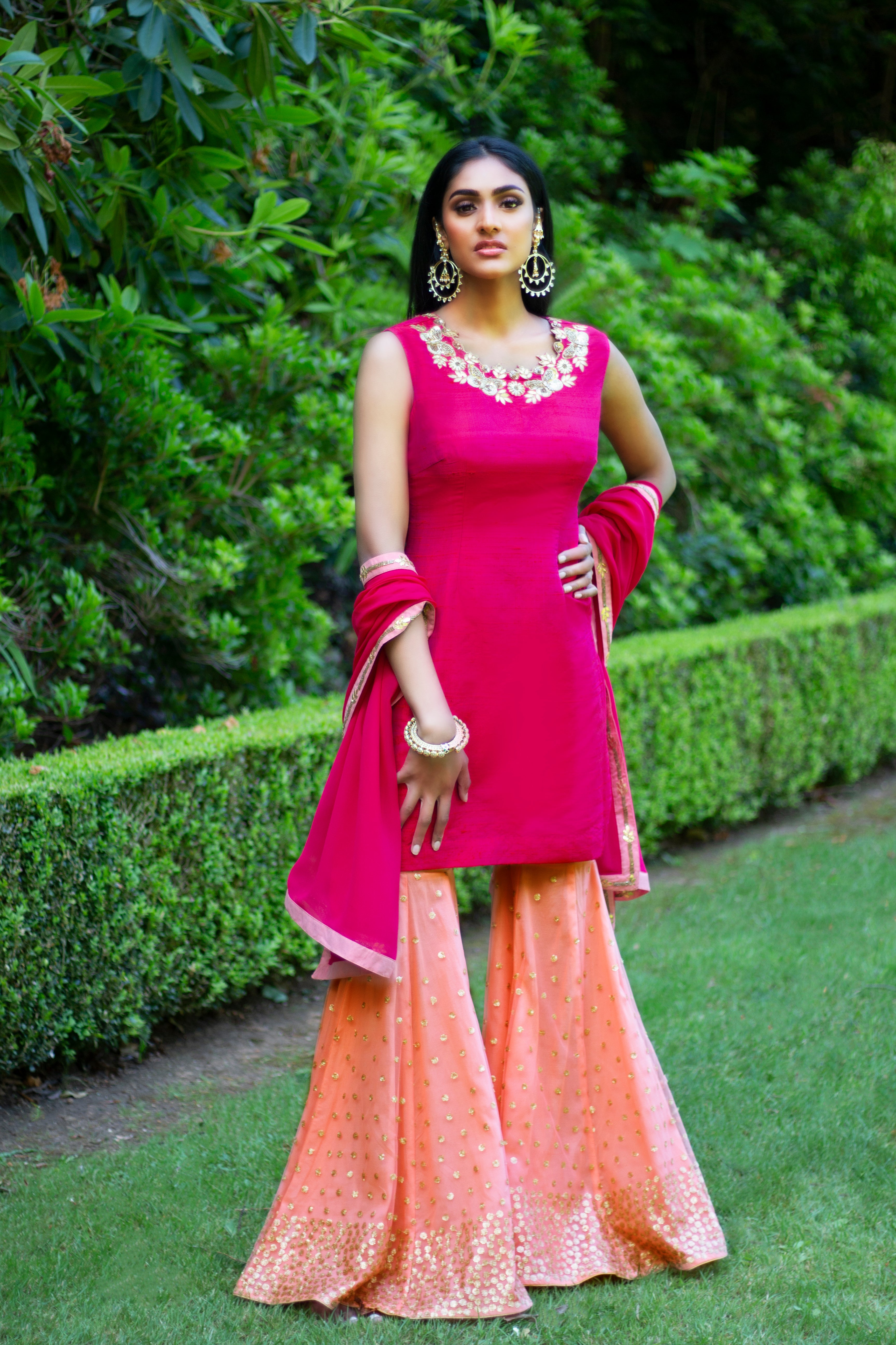 Pink and peach Rani Gharara Sharara by Couture Mantra featuring intricate embroidery and traditional styling.
