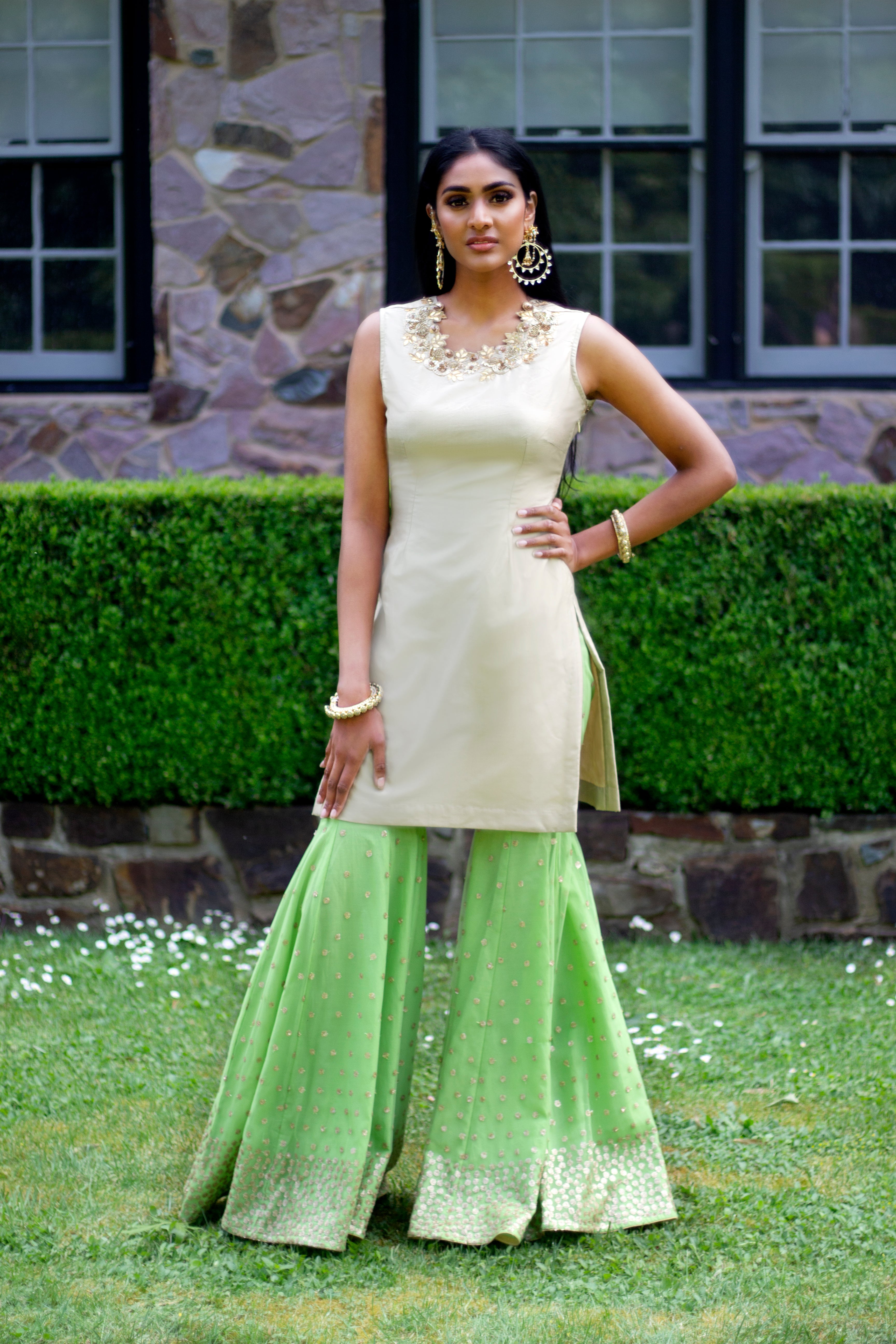 Beige and green Rani Gharara Sharara by Couture Mantra featuring intricate embroidery and traditional design.