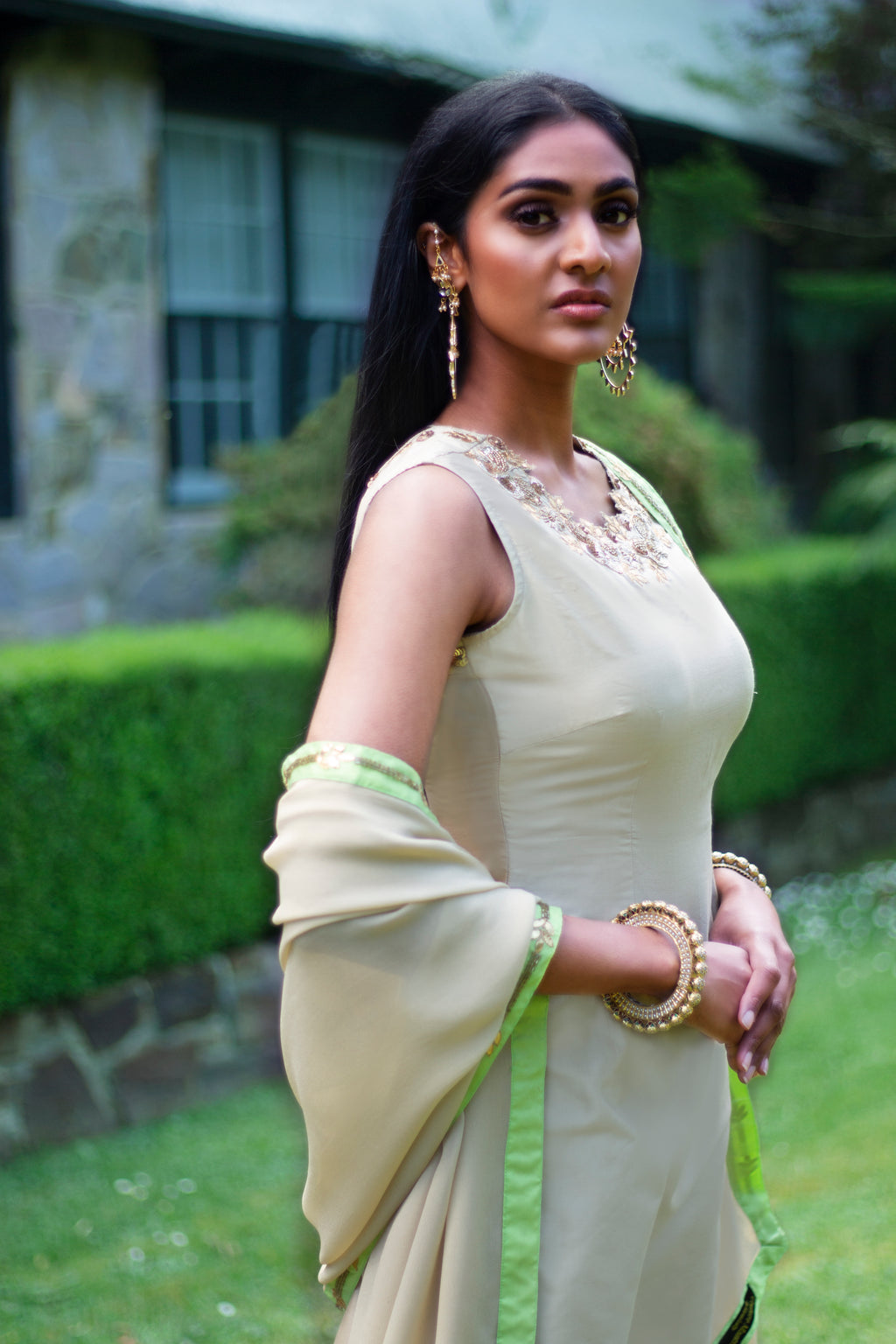 Beige and green Rani Gharara sharara from Couture Mantra, featuring traditional embroidery and flowy fabric.