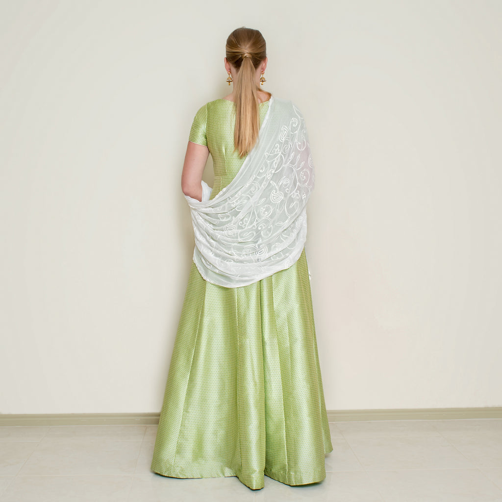 Green Bindi Anarkali dress by Nakir featuring intricate embroidery and flowing fabric, perfect for traditional celebrations.