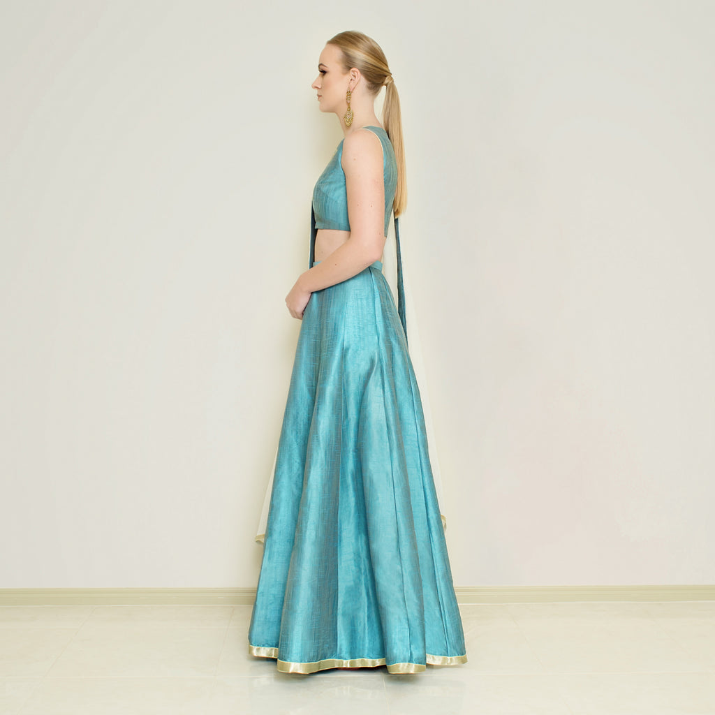 Blue halter neck lehenga set by Nakir featuring intricate embroidery and flowing fabric, perfect for festive occasions.