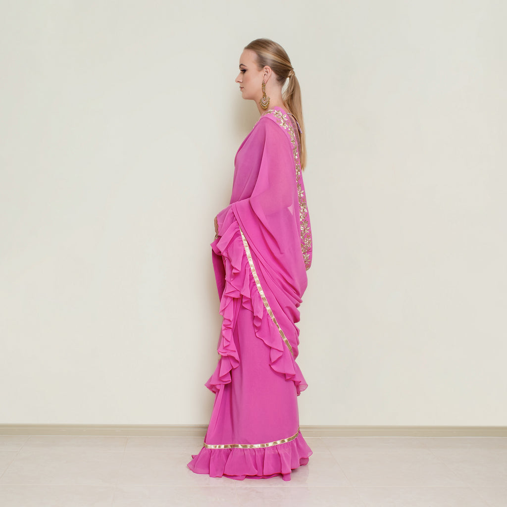 Nakir frill saree blouse featuring intricate embroidery and ruffled sleeves, displayed on a hanger.