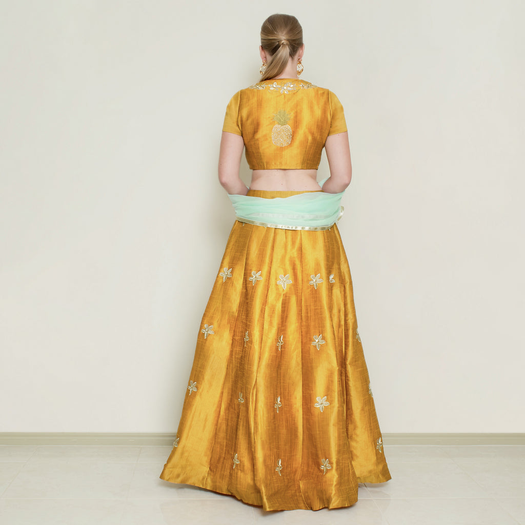 Nakir mustard pineapple lehenga set with intricate embroidery and traditional design, perfect for festive occasions.
