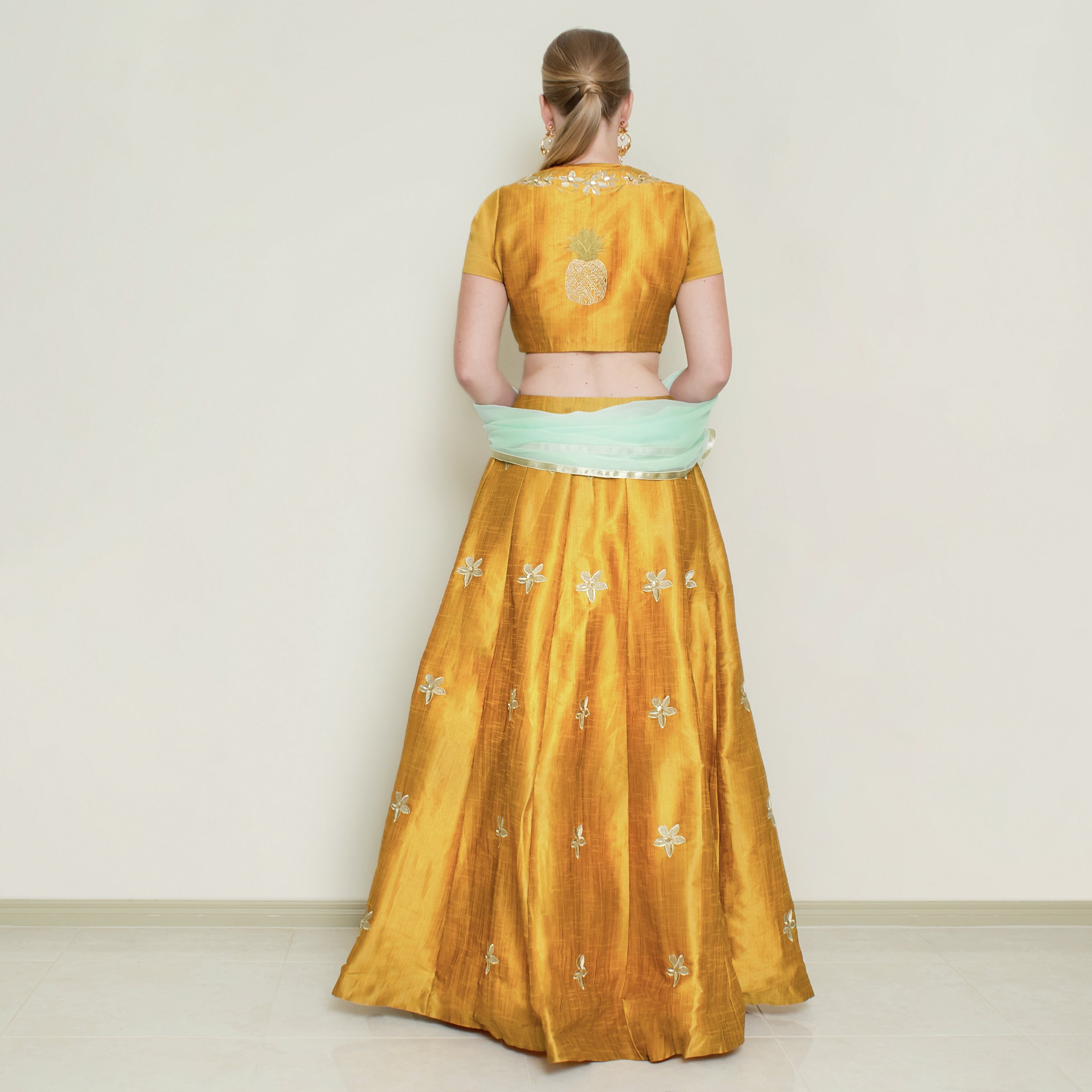 Nakir mustard pineapple lehenga set with intricate embroidery and traditional design, perfect for festive occasions.