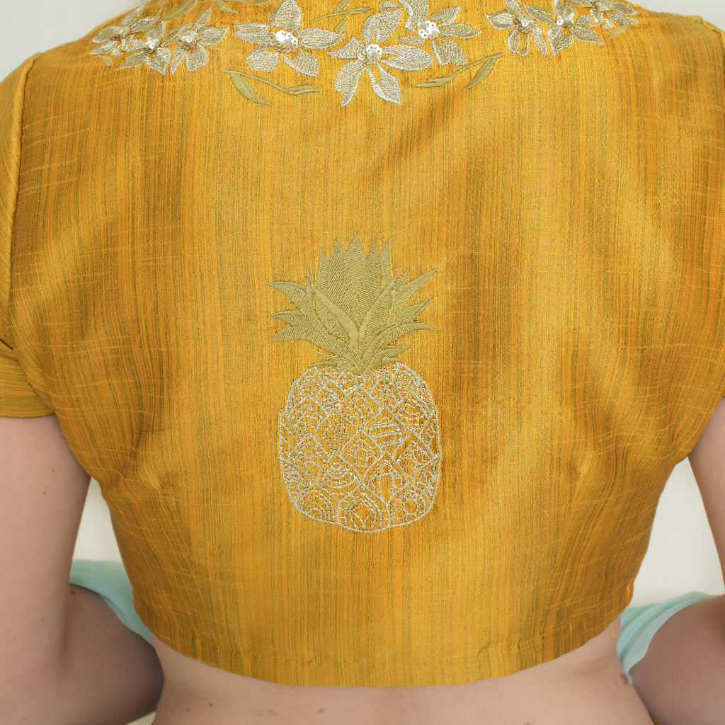 Nakir mustard pineapple lehenga set featuring traditional design with vibrant yellow fabric and intricate embroidery.
