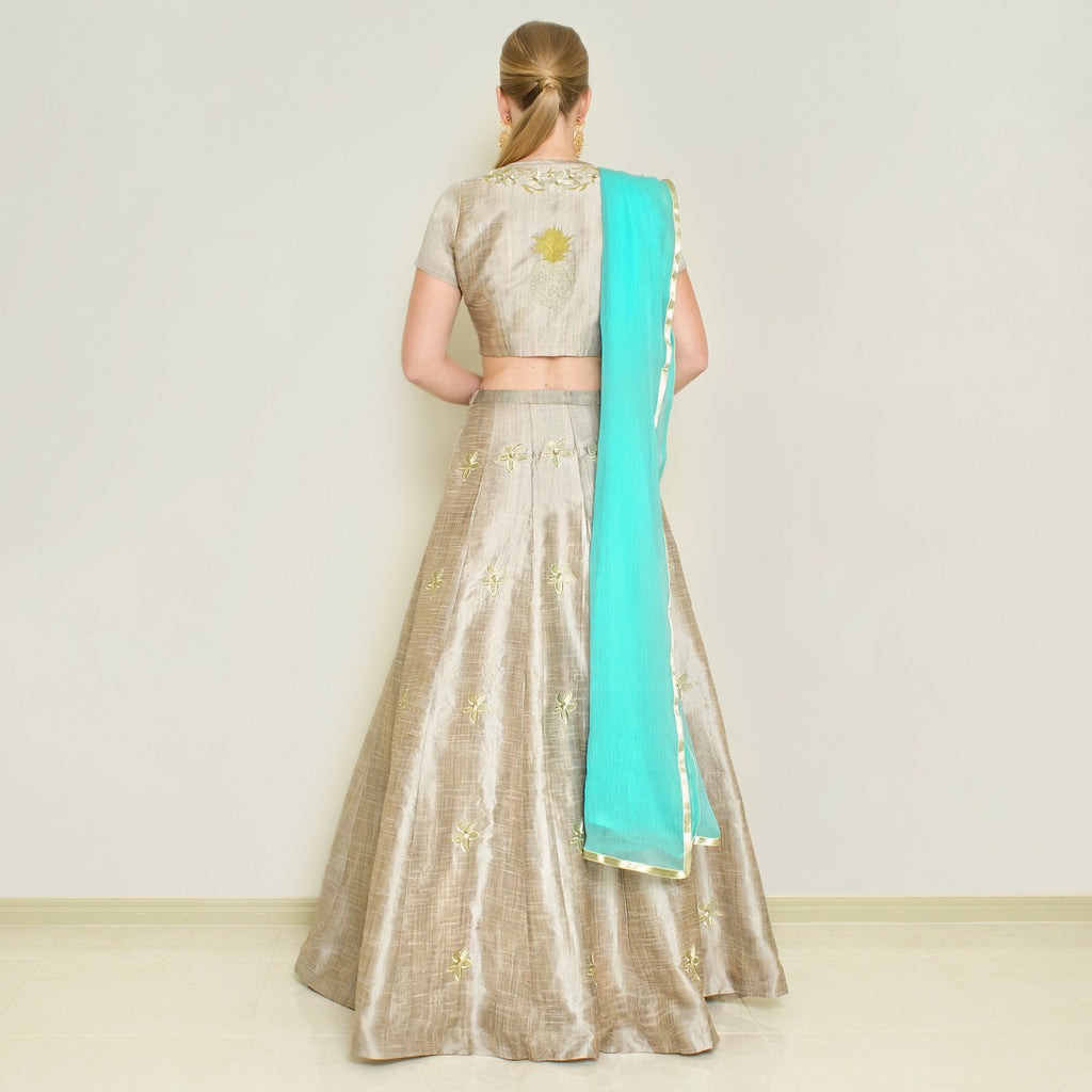 Stone grey pineapple lehenga set by Nakir, featuring intricate embroidery and traditional design, displayed on a mannequin.