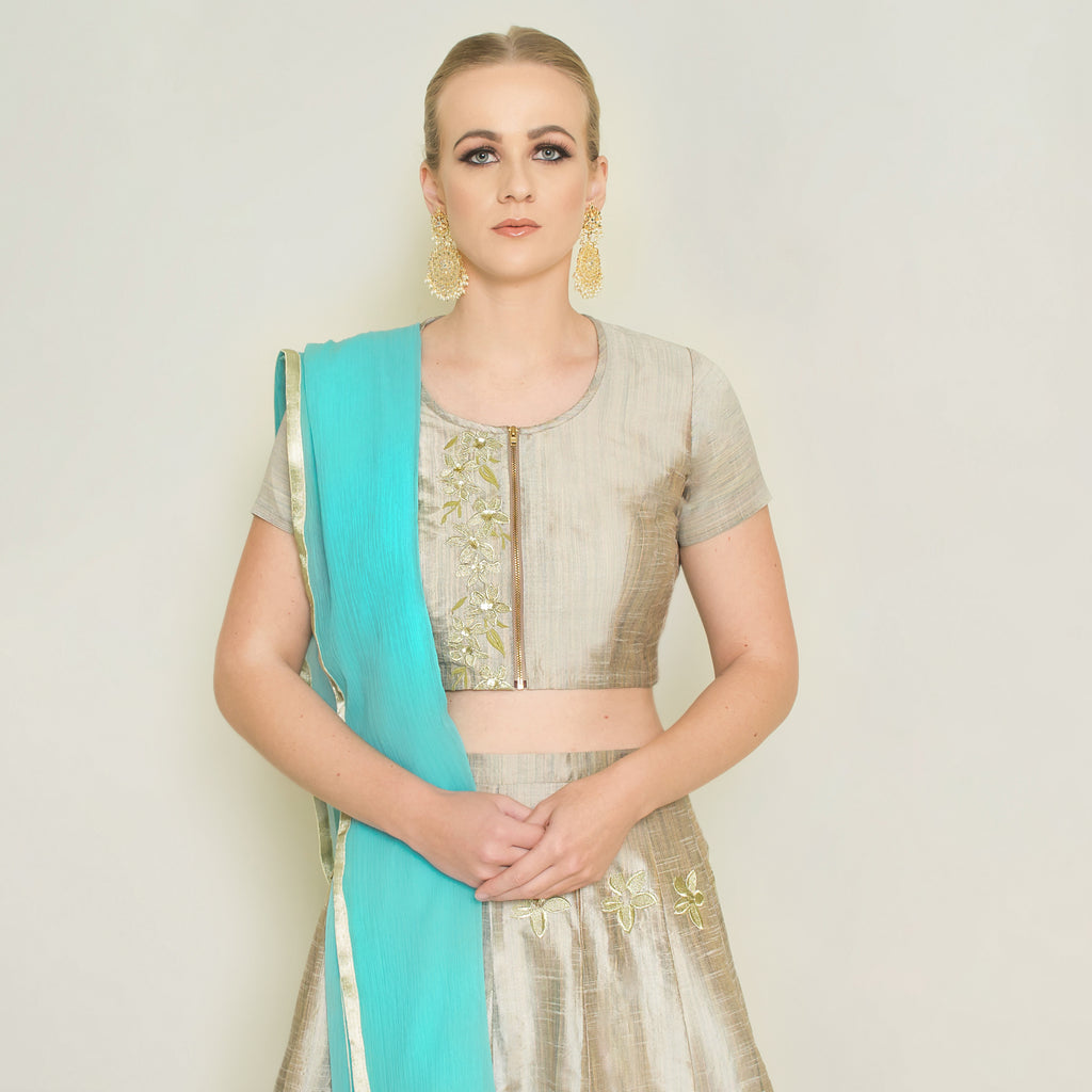 Stone grey Pineapple Lehenga set by Nakir featuring intricate embroidery and traditional design on fabric.