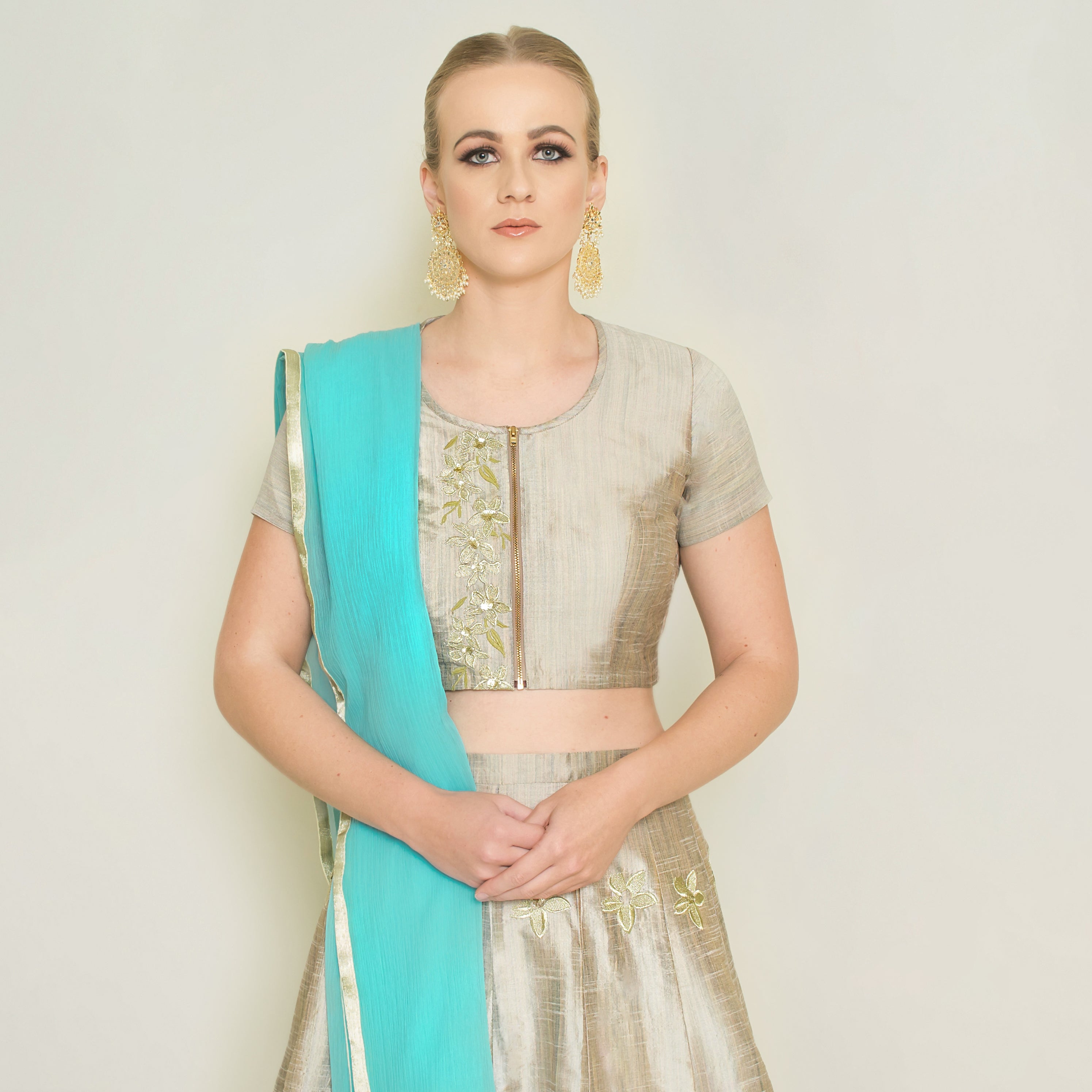Stone grey Pineapple Lehenga set by Nakir featuring intricate embroidery and traditional design on fabric.
