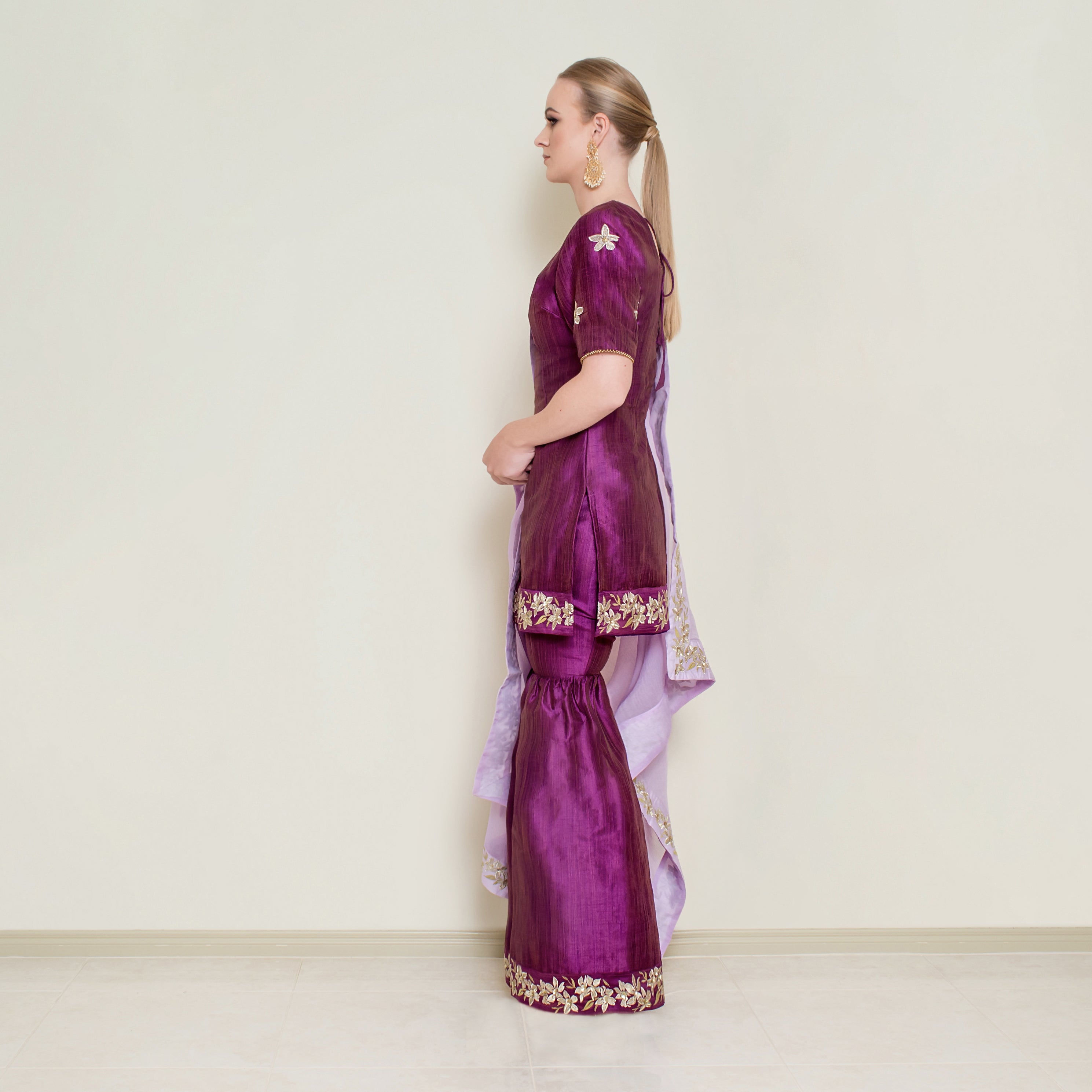 Purple embroidered sharara set by Nakir, featuring intricate embroidery and flowing fabric, ideal for traditional festive wear.