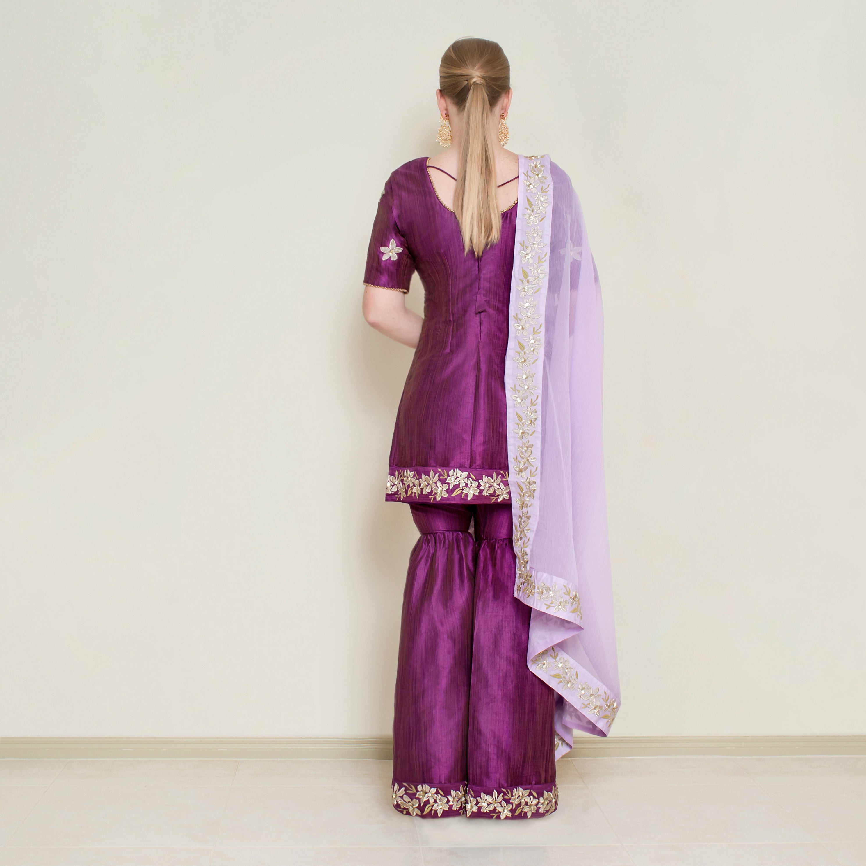 Purple embroidered Sharara set by Nakir, featuring intricate embroidery and traditional design, displayed on a mannequin.