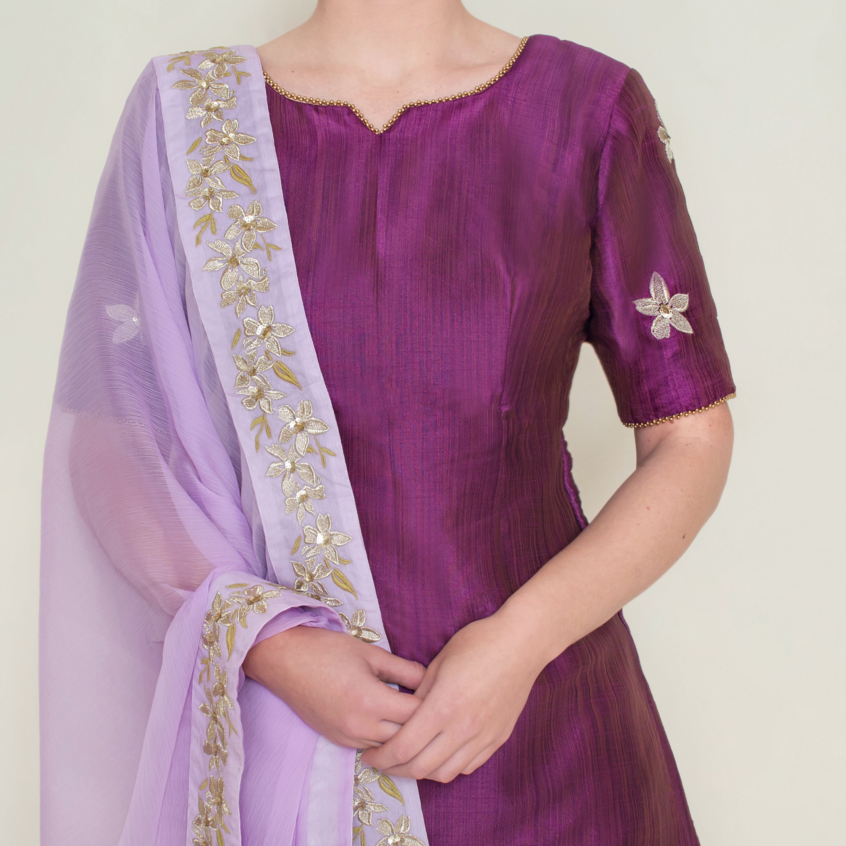 Purple embroidered sharara set by Nakir, featuring intricate embroidery and flowing fabric for traditional elegance.