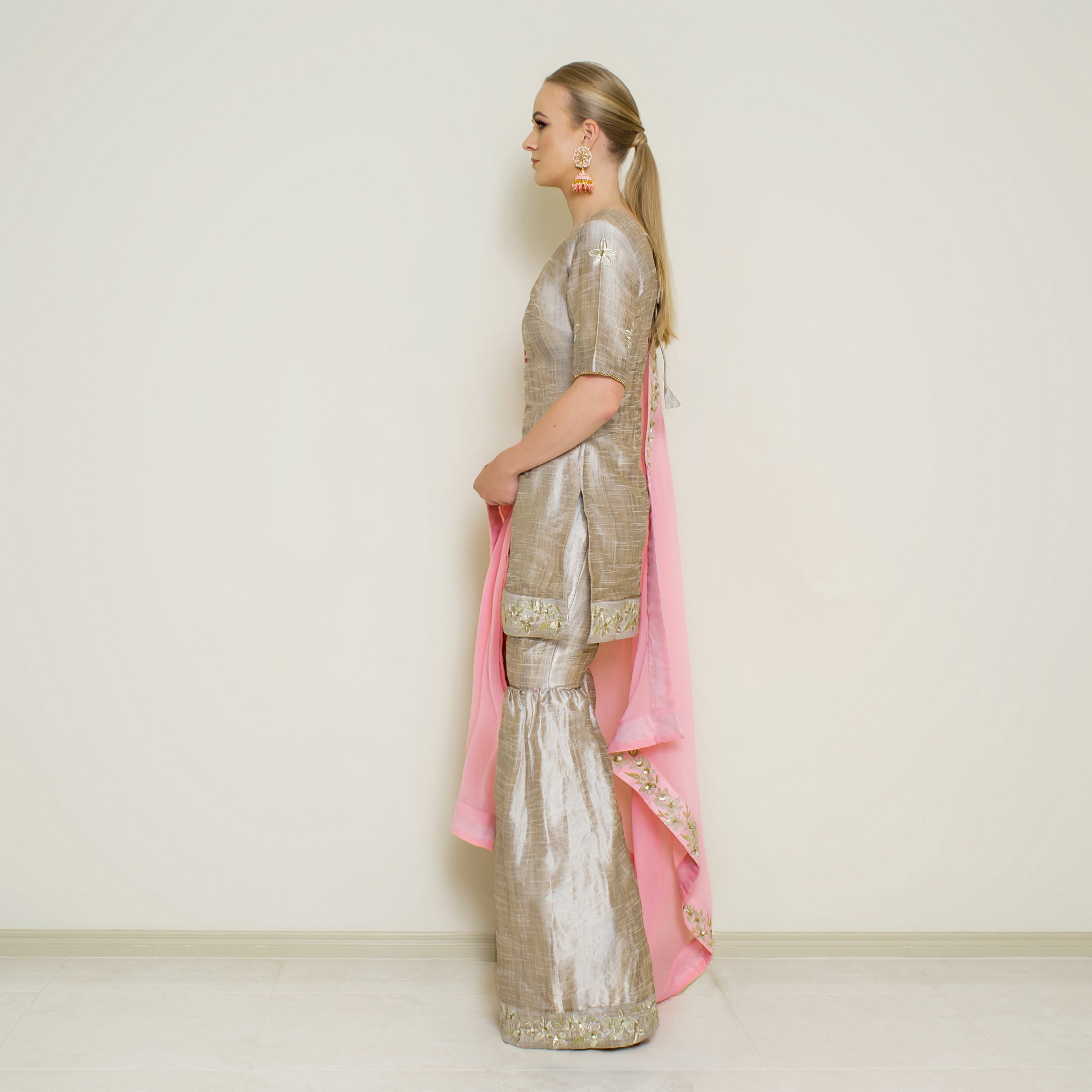 Stone grey embroidered sharara set by Nakir, featuring intricate embroidery and flowing fabric, perfect for traditional occasions.