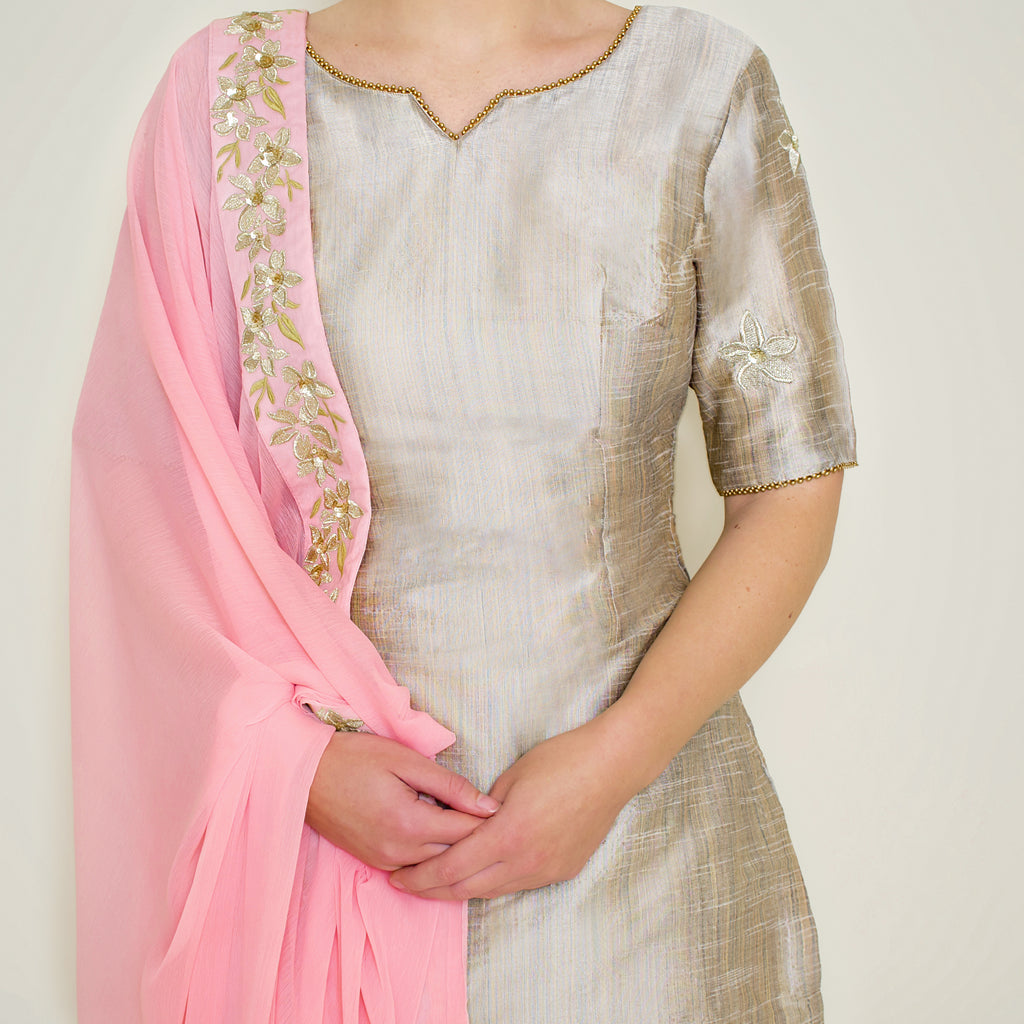 Stone grey embroidered sharara set by Nakir featuring intricate embroidery and flowing fabric, perfect for festive occasions.