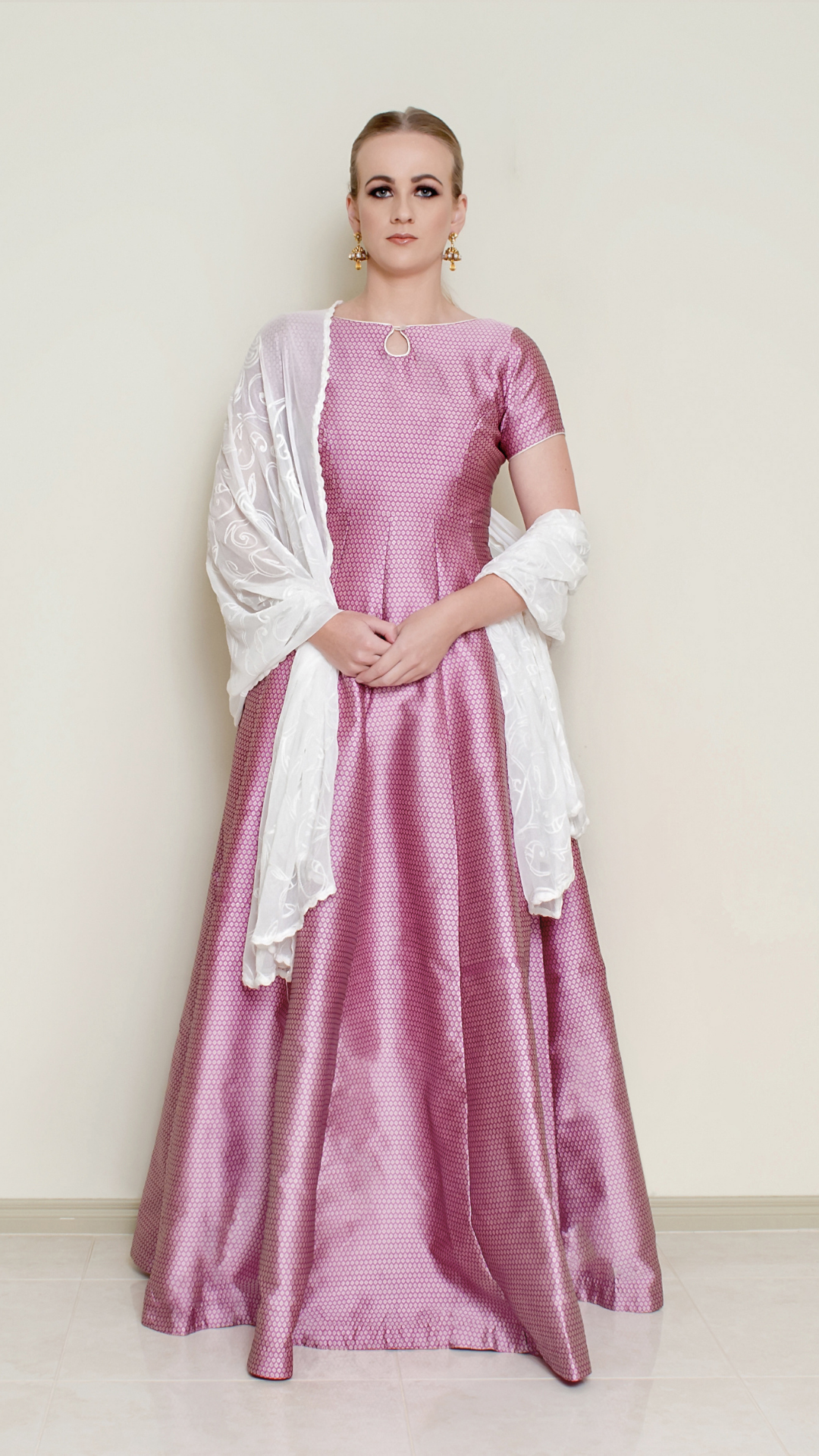 Pink Bindi Anarkali dress by Nakir featuring traditional embroidery and flowing fabric, ideal for festive occasions.
