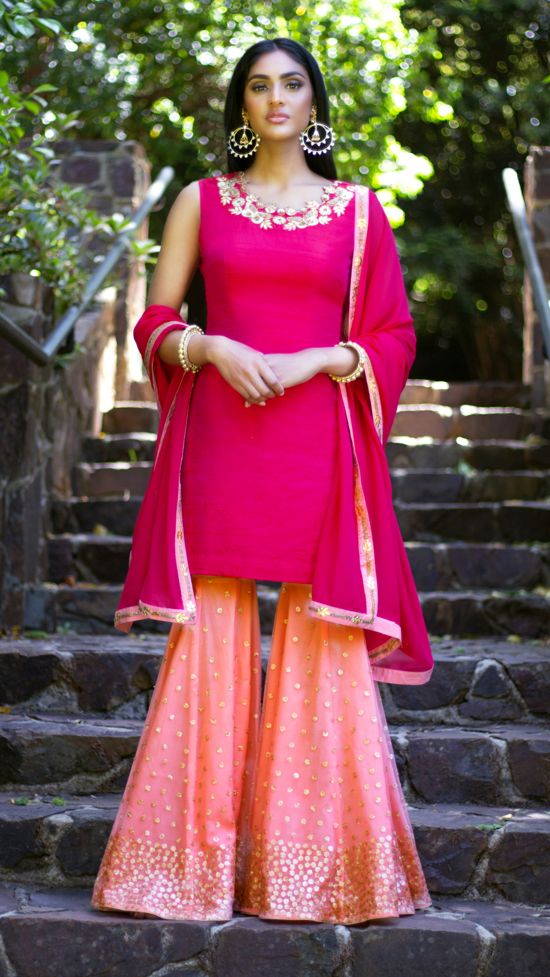 Pink and peach Rani Gharara by Couture Mantra, featuring intricate embroidery and traditional sharara style for elegant Indian wear.