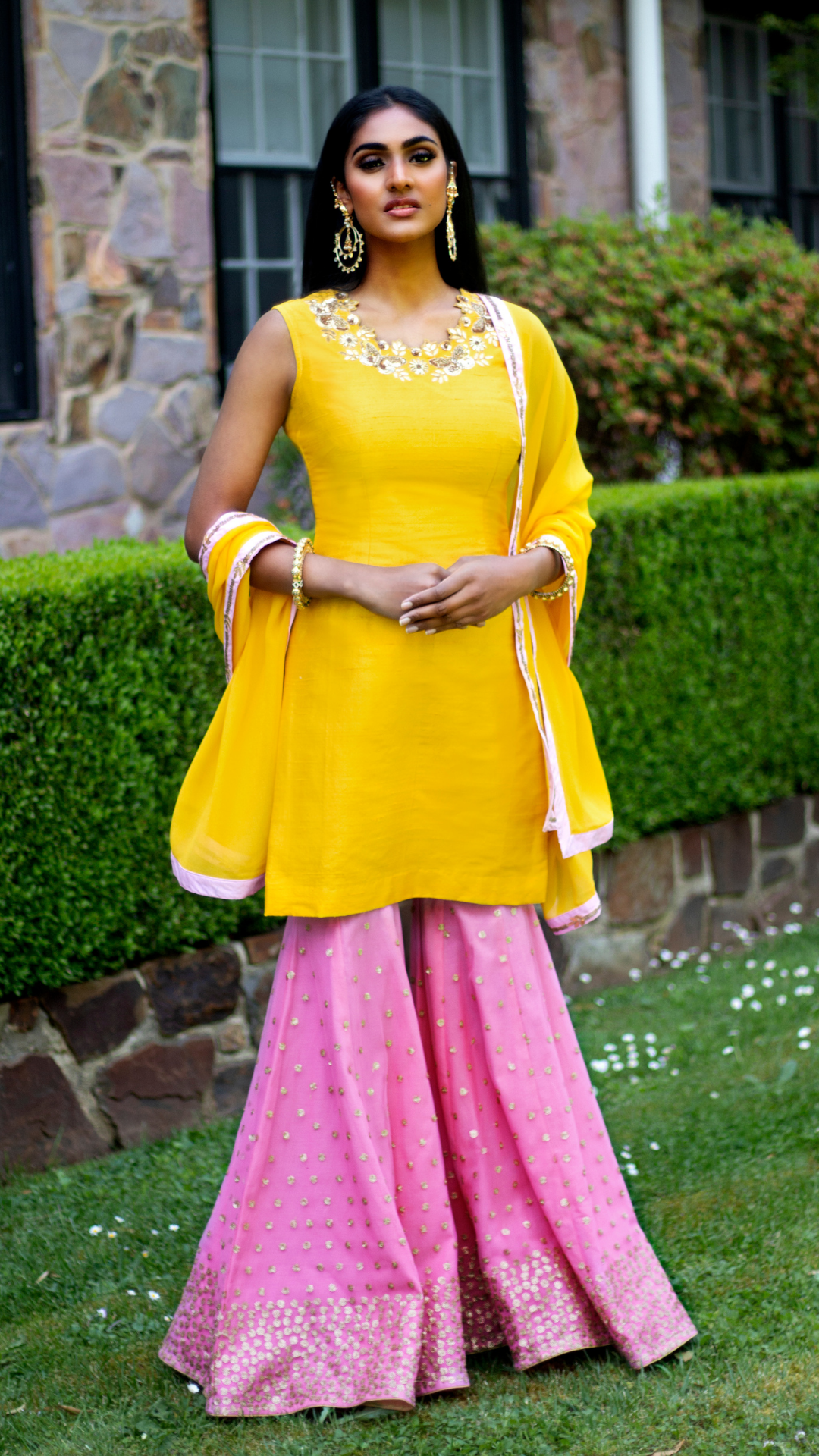 Yellow and pink Rani Gharara set by Couture Mantra, featuring a traditional Sharara with intricate embroidery and vibrant colors.