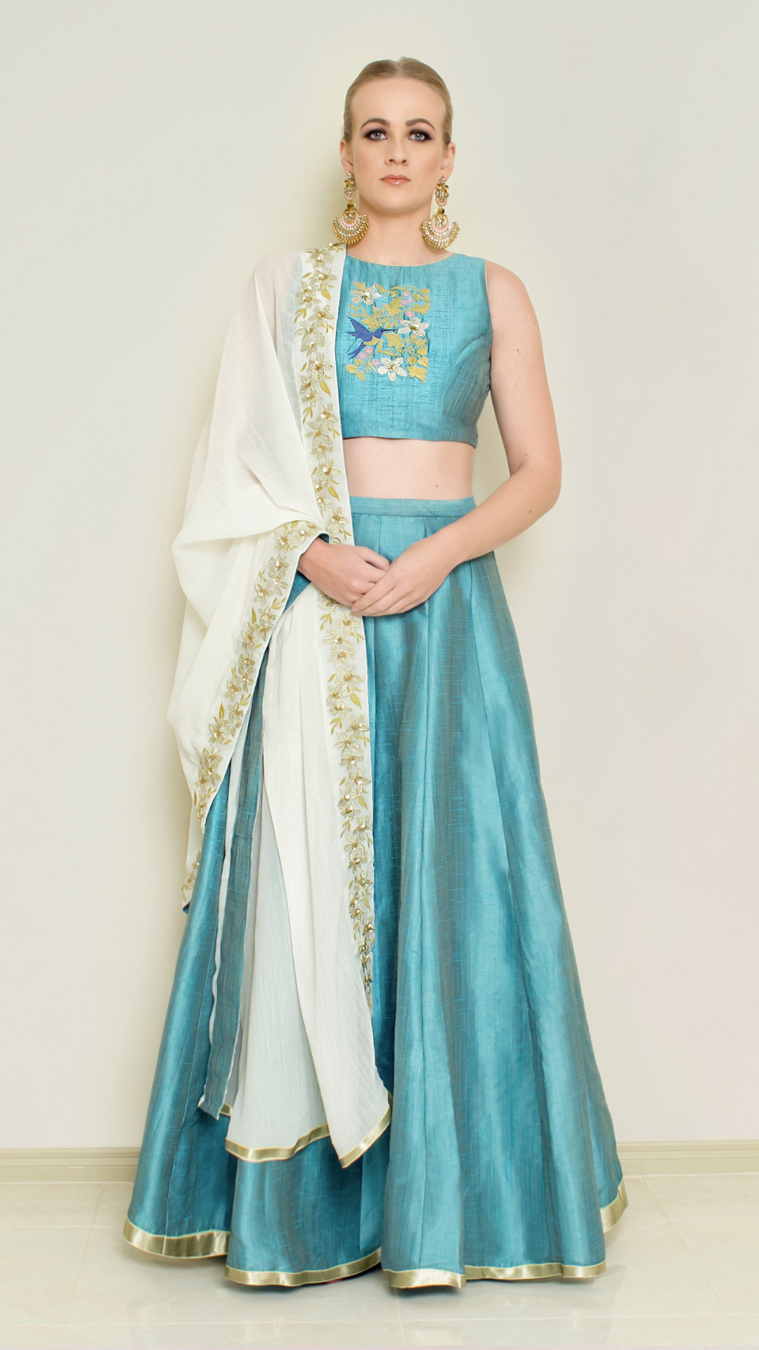 Blue halter neck Lehenga set by Nakir featuring intricate embroidery and flowing fabric, perfect for traditional or festive occasions.