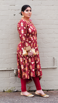Maroon Patiyala frock by Amanpreet with intricate embroidery, displayed on a hanger against a white background.