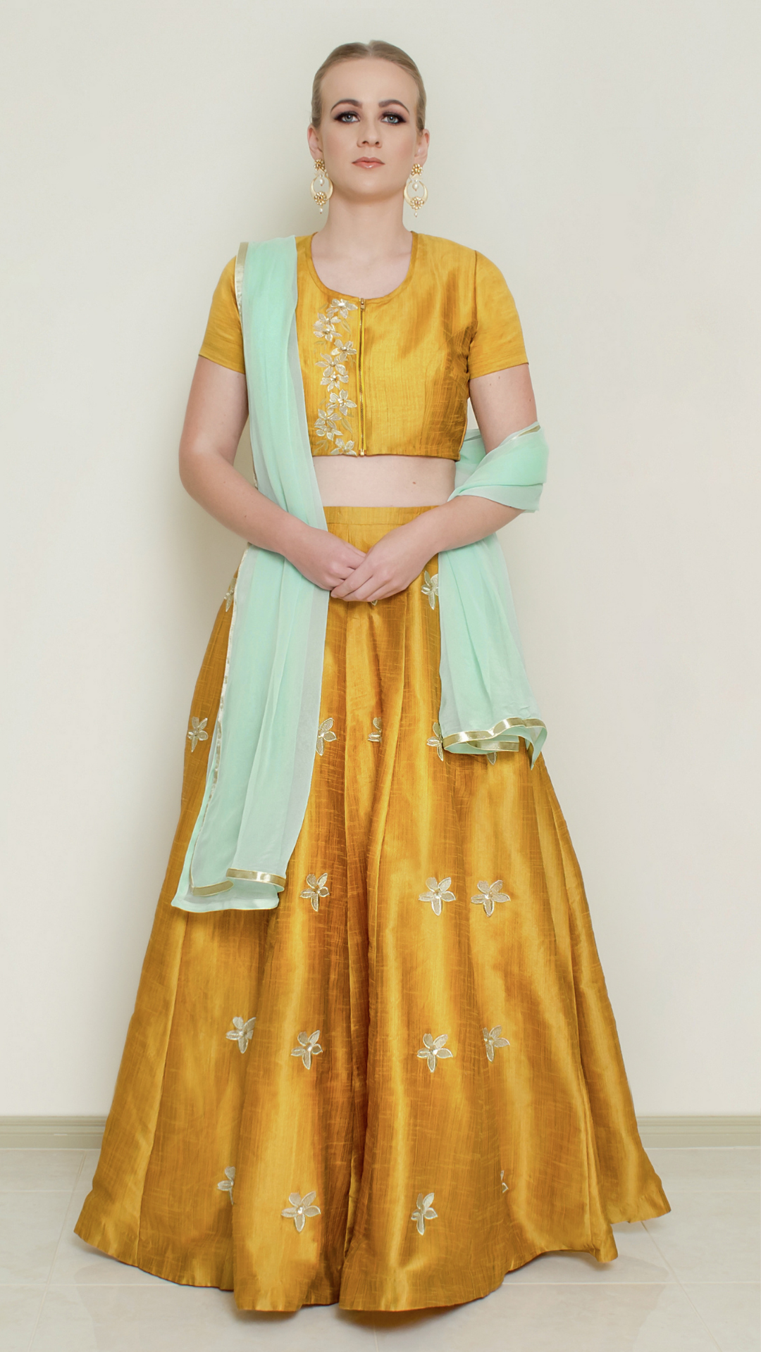 Mustard pineapple print lehenga set by Nakir, featuring traditional embroidery and a flowing skirt for festive occasions.