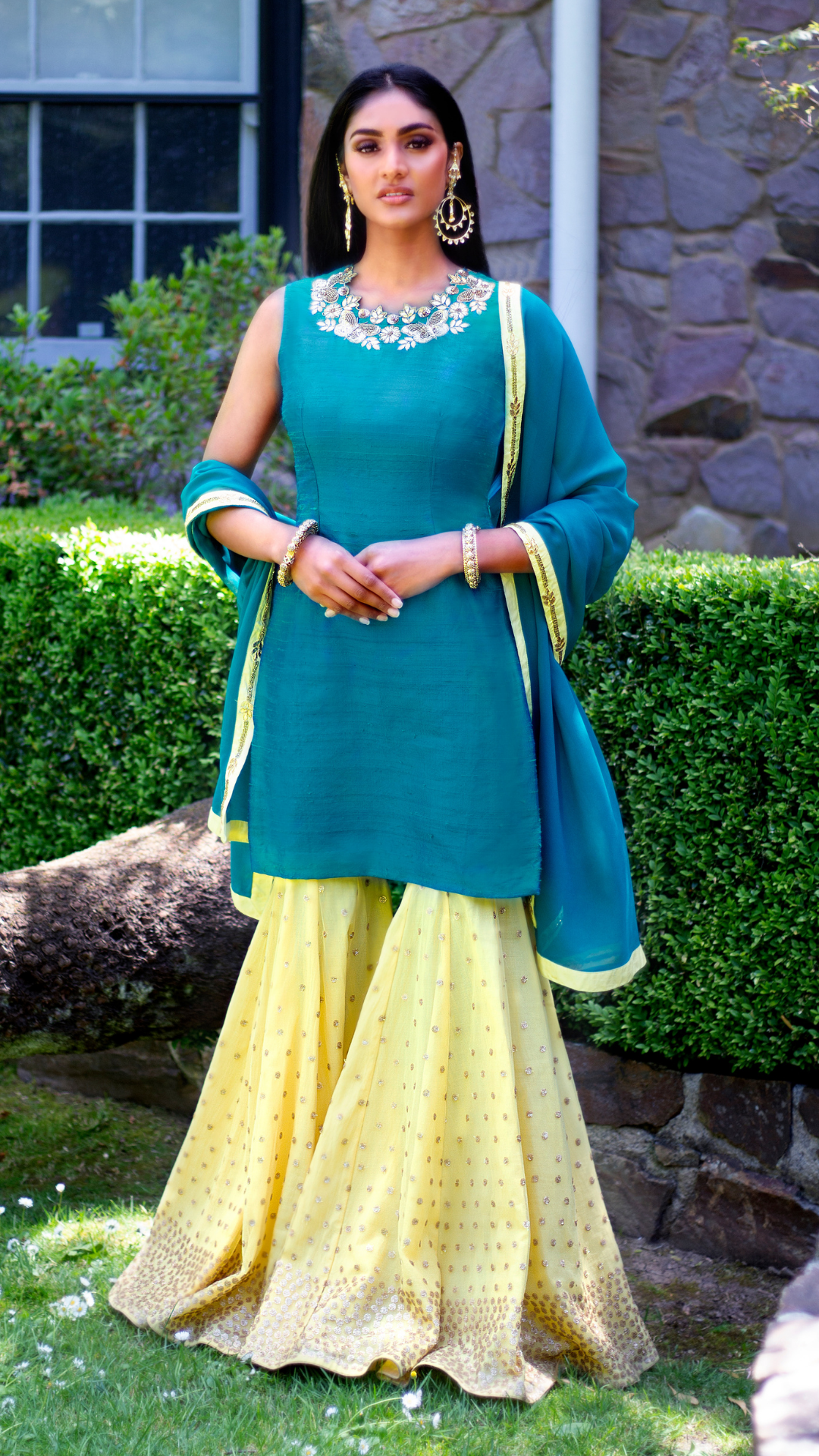 Peacock blue and yellow Rani Gharara from Couture Mantra with intricate embroidery and traditional Indian design.