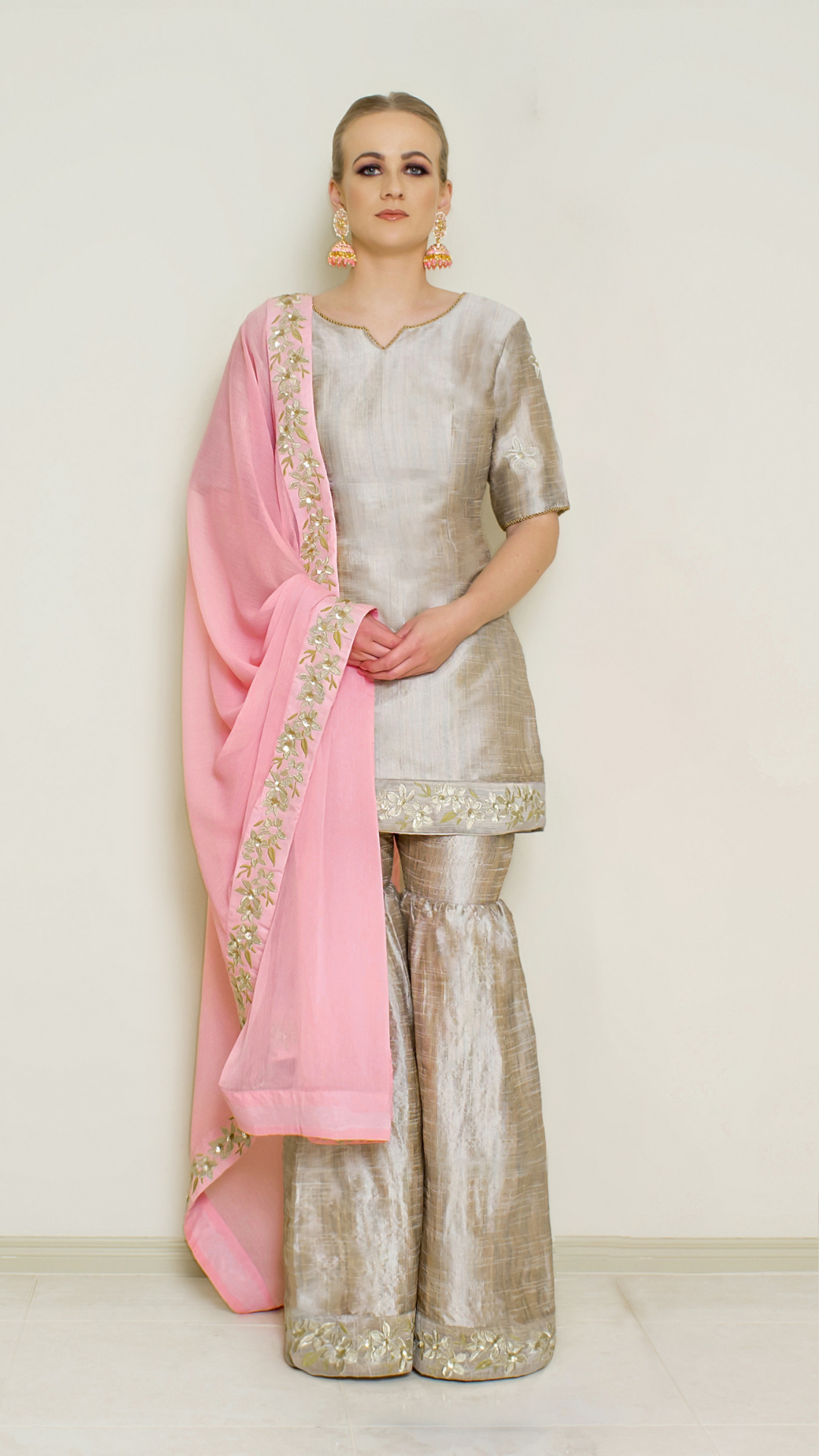 Stone grey embroidered sharara set by Nakir, featuring intricate embroidery and traditional design on the fabric.
